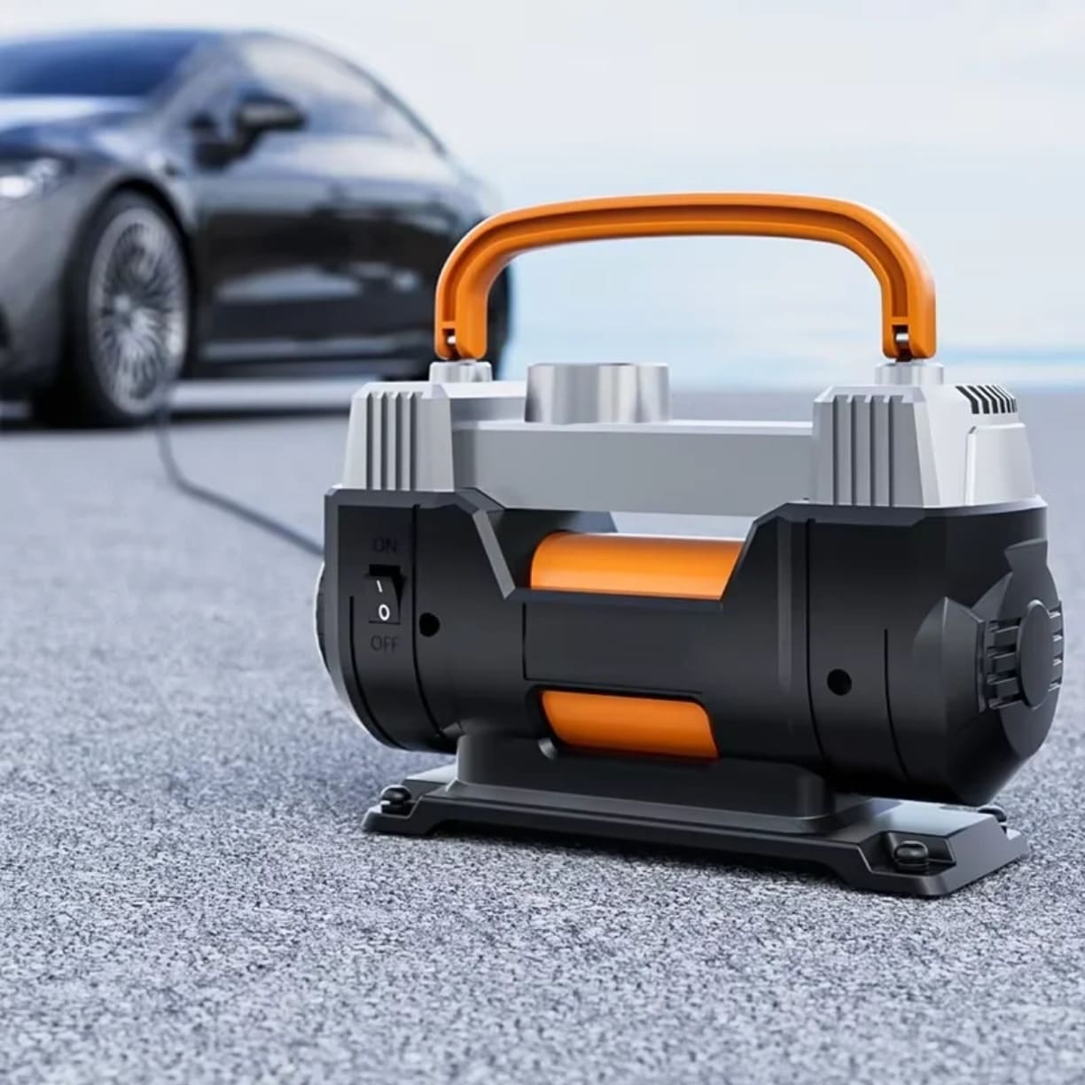 Prenosivi kompresor za automobil postavljen pored vozila