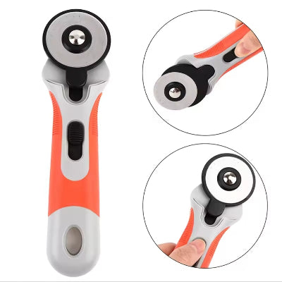 Rotacioni sekac za tkaninu i materijale u narandzasto-sivoj boji, sa ergonomskom ruckom za udoban rad i precizno rezanje.