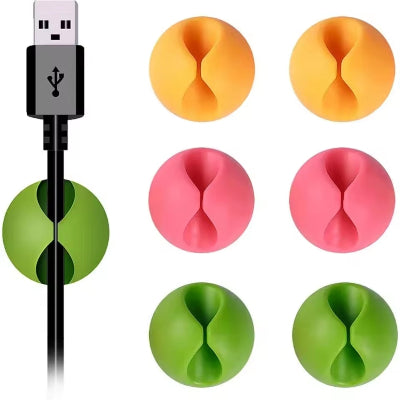 Raznovrsni oblici i boje silikonskih organizera za kablove. Pogodno za razne tipove kablova i uredjaja.