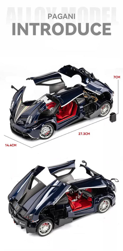 Dve slike modela tamnoplavog Pagani Huayra automobila sa otvorenim vratima i crvenim enterijerom prikazane su jedna iznad druge na beloj pozadini. Na gornjoj slici su prikazane dimenzije modela: duzina 27.3cm, sirina 14.4cm i visina 7cm, kao i daljinski upravljac. 