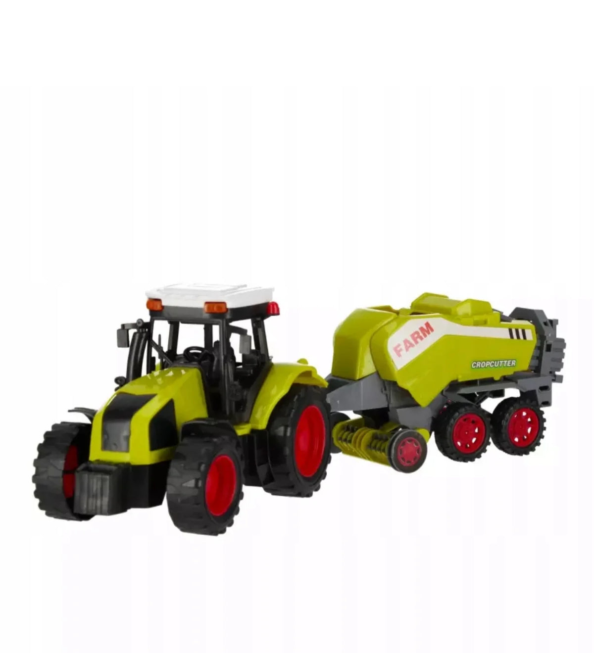 Zeleni deciji traktor igracka sa prikolicom balirkom na beloj pozadini