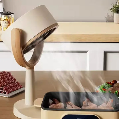 Podesivi mini kuhinjski aspirator iznad tiganja sa mesom