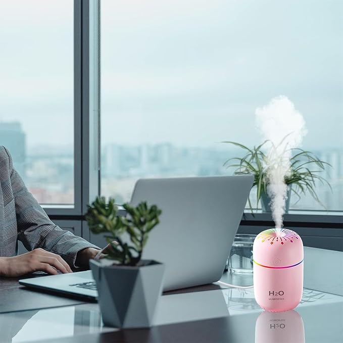 Roze mini ovlazivac vazduha pored laptopa u kancelariji