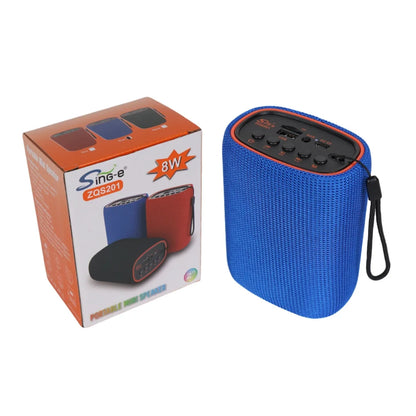 Plavi prenosni bluetooth zvucnik pored ambalaze