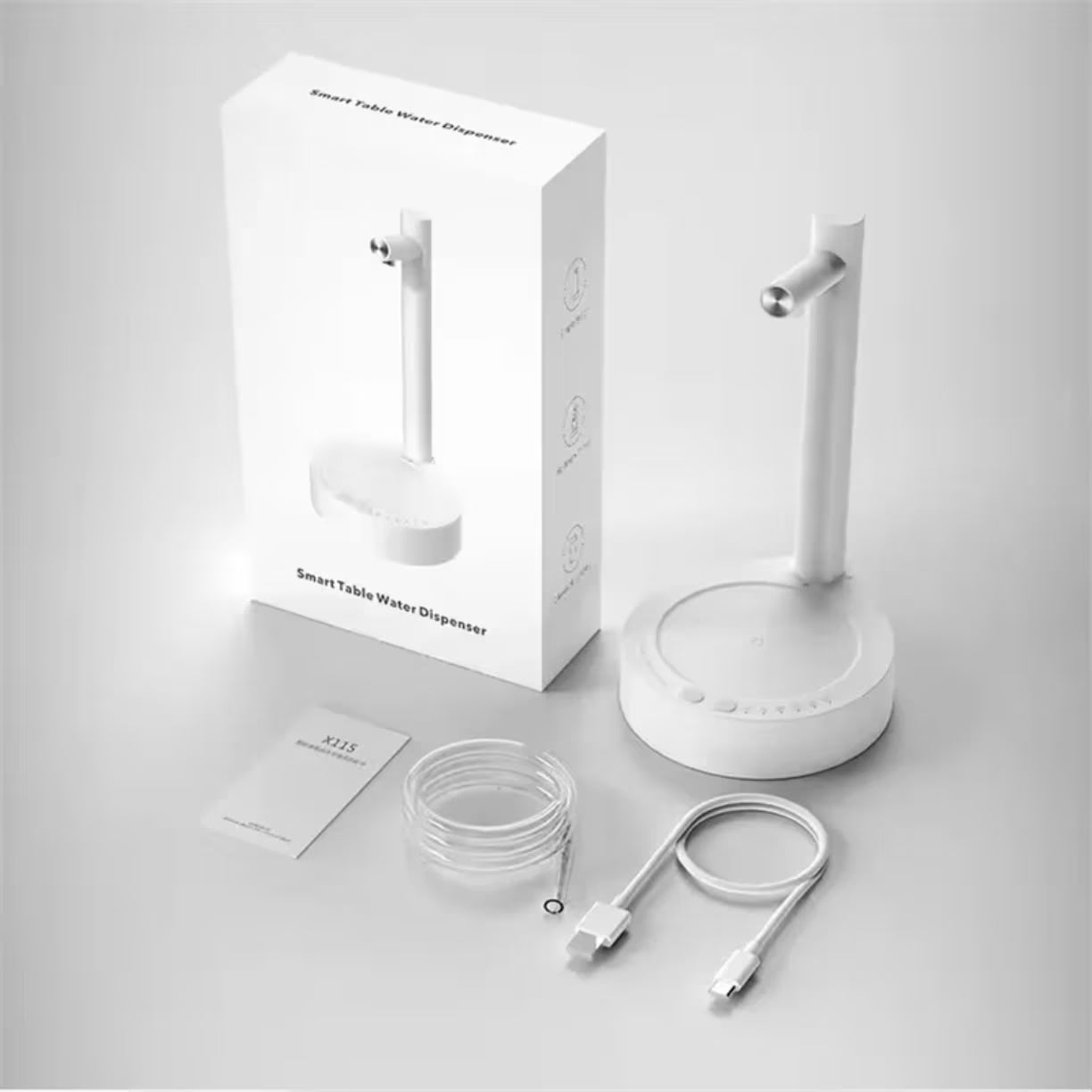 Beli uredjaj prikazan pored originalne kutije, uputstva, savitljivog creva i kabla za punjenje