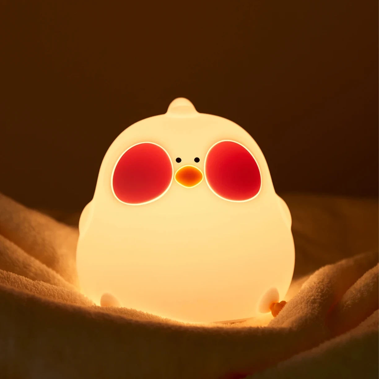 Silikonska nocna lampa pile sa toplim zutim svetlom na krevetu