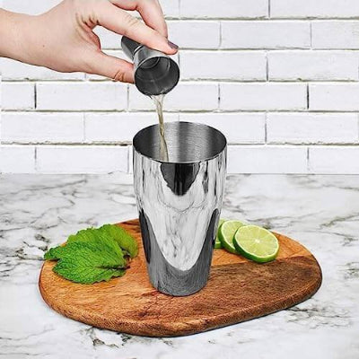 Ruke sipaju sastojke u shaker. Priprema koktela sa profesionalnim alatom, za pravljenje pica kod kuce ili u restoranu.