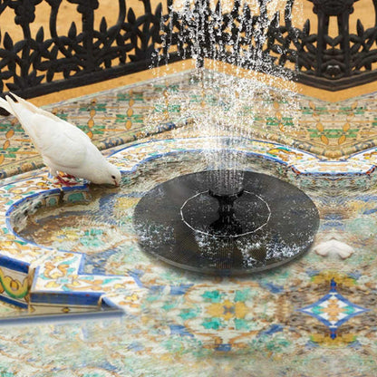 Solarna fontana za bazen, jezerce, bastu. Bela golubica pije vodu iz fontane. Dekoracija za dvoriste.