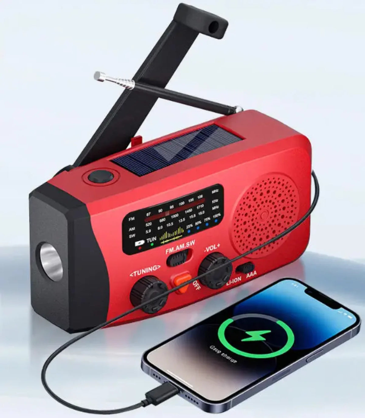 Crveni solarni krizni radio koji puni mobilni telefon preko USB kabla