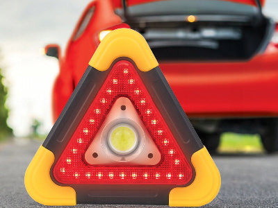 Prikaz trougla upozorenja postavljenog iza automobila, idealan za bezbednost na putu, signalizira kvar i opasnost.